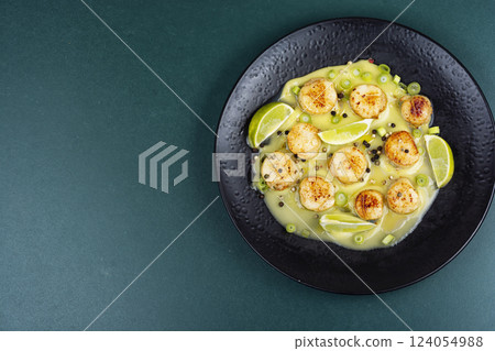 Delicious scallops with sauce. Delicious scallops with sauce. 124054988