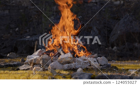Beautiful Crackling Campfire in a Rocky Landscape , Sunrise , Authentic Place 124055027