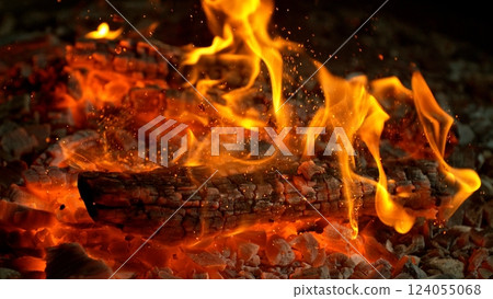 Close-up of Hot Embers with Flying Sparks . Concept of heating grills or ovens Close-up of Hot Embers with Flying Sparks . Concept of heating grills or ovens 124055068