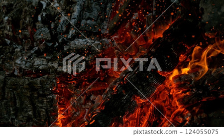 Close-up of Hot Embers with Flying Sparks . Concept of heating grills or ovens Close-up of Hot Embers with Flying Sparks . Concept of heating grills or ovens 124055075