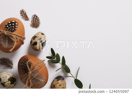 Easter eggs decorated with feathers and twine. Space for your text. 124055097