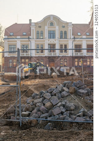 Construction Site with Rocks and Excavator, Building Renovation, Infrastructure Work, Fenced. High quality photo Construction Site with Rocks and Excavator, Building Renovation, Infrastructure Work, Fenced. High quality photo 124055313