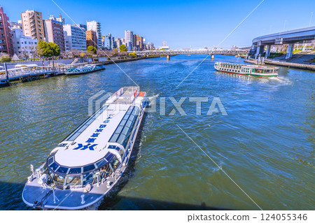 A rare view of the Tokyo cityscape in Japan. Three water buses, including Emeraldas, Ajisai (foreground), and Dokan, lined up at the Asakusa water bus terminal A rare view of the Tokyo cityscape in Japan. Three water buses, including Emeraldas, Ajisai (foreground), and Dokan, lined up at the Asakusa water bus terminal 124055346