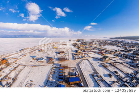 Aerial top view of Khuzhir village largest island of Lake Baikal. Famous Shamanka rock and small sea covered snow. frozen morning winter landscape. Clear ice, Cape Burkhan, Olkhon, Siberia, Russia Aerial top view of Khuzhir village largest island of Lake Baikal. Famous Shamanka rock and small sea covered snow. frozen morning winter landscape. Clear ice, Cape Burkhan, Olkhon, Siberia, Russia 124055689