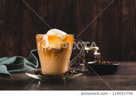 Delicious sweet affogato coffee with creamy ice cream in a cup on the table Delicious sweet affogato coffee with creamy ice cream in a cup on the table 124055794