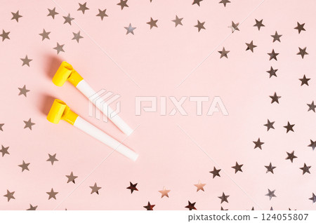 Happy April Fools' Day whistles and stars on pink top view copy space 124055807