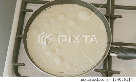 Cooking Pancake Batter Lightly on the Stovetop for a Delicious Breakfast or Brunch Experience 124056114