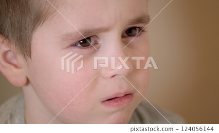 A Thoughtful Child Portrait featuring a captivating and intense expression that draws attention 124056144