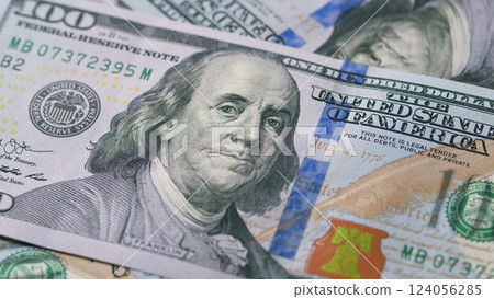 A Detailed CloseUp View of U.S. Hundred Dollar Bills Carefully Laid Out on a Table Surface 124056285
