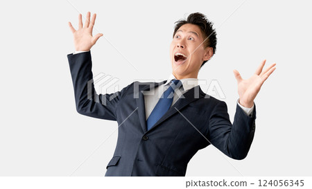 A smiling male businessman who is happy with a fist pump 124056345