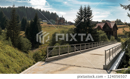 Concrete Bridge with a View of Hills and Quaint Village Homes Concrete Bridge with a View of Hills and Quaint Village Homes 124056507