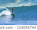Male surfer on a blue wave 124056744