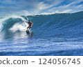 Male surfer on a blue wave 124056745