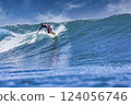 Male surfer on a blue wave 124056746