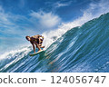 Male surfer on a blue wave 124056747
