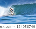 Male surfer on a blue wave 124056749