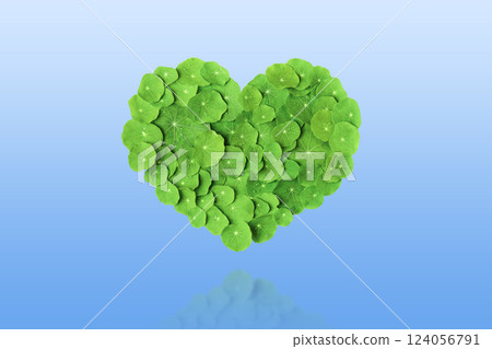 Mockup of the heart is made of green leaf isolated on gradient blue background. Earth day concept and green recycling. World Nature Conservation Day Mockup of the heart is made of green leaf isolated on gradient blue background. Earth day concept and green recycling. World Nature Conservation Day 124056791