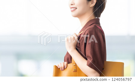 微笑的女人/女商人拿著一個袋子 124056797