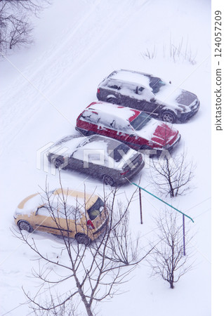 Parked cars covered with snow. Bad weather in the city. Snowy day. 124057209