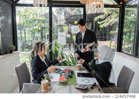 Consulting and Sustainable Practices. A proactive team discusses green strategies for improving business sustainability in an eco-friendly environment. 124057486