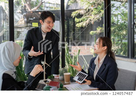 Climate Action and Team Collaboration. Professionals discussing solar energy solutions in a business setting. 124057487