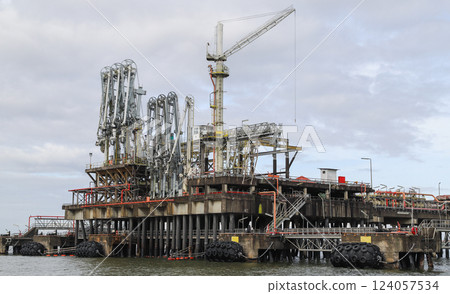 Offshore industrial jetty, close up photo taken from the water on a cloudy day 124057534