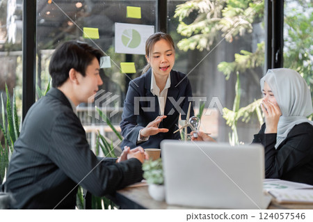 Sustainable Business Planning. A diverse team discussing renewable solutions in a bright, inspirational workspace. Sustainable Business Planning. A diverse team discussing renewable solutions in a bright, inspirational workspace. 124057546
