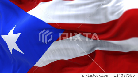 Puerto Rico flag waving in the wind with close-up of fabric and star 124057599