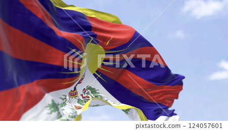 Tibetan flag waving outdoors with snow lions and rising sun symbolizing freedom Tibetan flag waving outdoors with snow lions and rising sun symbolizing freedom 124057601