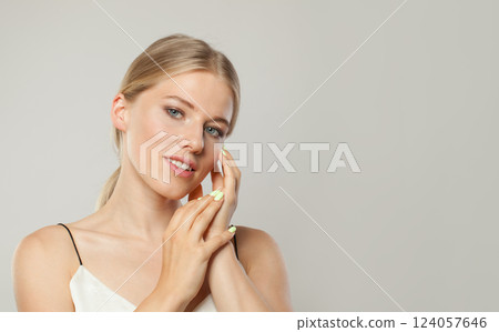 Lovely smiling woman. Female model with blond hairstyle and clean skin, facial treatment 124057646