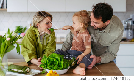 Family preparing lettuce salad to celebrate Easter Green Thursday. Family preparing lettuce salad to celebrate Easter Green Thursday. 124058192
