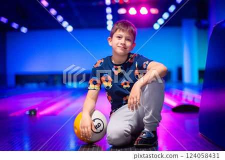 Young boy child having fun and playing bowling 124058431