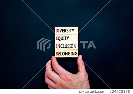 DEIB diversity equity inclusion belonging symbol. Concept words DEIB diversity equity inclusion belonging on blocks. Beautiful black background. Business diversity equity inclusion belonging concept. DEIB diversity equity inclusion belonging symbol. Concept words DEIB diversity equity inclusion belonging on blocks. Beautiful black background. Business diversity equity inclusion belonging concept. 124058578