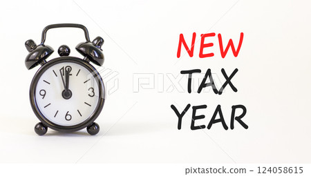 New tax year symbol. Concept words New tax year on beautiful white paper. Beautiful white background. Black alarm clock. Business new tax year concept. Copy space. 124058615