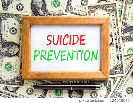 Suicide prevention symbol. Concept words Suicide prevention on beautiful wooden picture frame. Dollar bills. Beautiful background from dollar bills. Psychological suicide prevention concept Copy space Suicide prevention symbol. Concept words Suicide prevention on beautiful wooden picture frame. Dollar bills. Beautiful background from dollar bills. Psychological suicide prevention concept Copy space 124058623