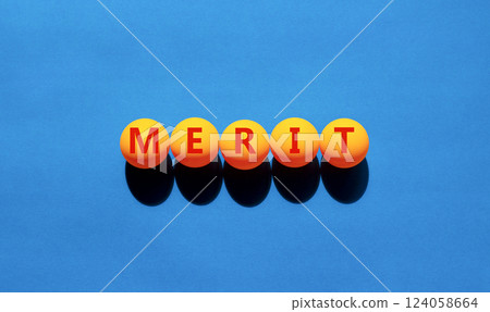 Merit symbol. Concept word Merit on beautiful yellow tennis ping pong balls. Beautiful wooden table wooden background. Business lifestyle merit concept. Copy space. 124058664