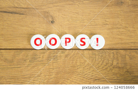 Oops symbol. Concept word Oops on beautiful white circles. Beautiful wooden table wooden background. Business lifestyle oops concept. Copy space. Oops symbol. Concept word Oops on beautiful white circles. Beautiful wooden table wooden background. Business lifestyle oops concept. Copy space. 124058666