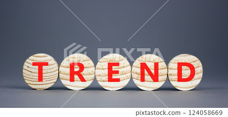 Trend and trending symbol. Concept word Trend on beautiful wooden circles. Beautiful grey table grey background. Business lifestyle trend and trending concept. Copy space. 124058669