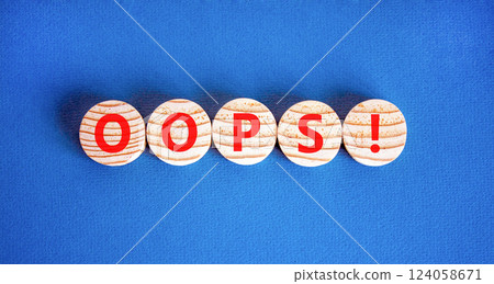 Oops symbol. Concept word Oops on beautiful wooden circles. Beautiful blue table blue background. Business lifestyle oops concept. Copy space. 124058671