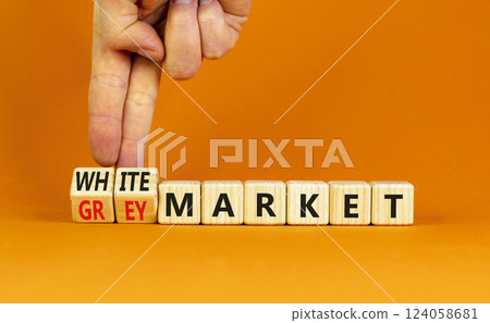 Grey or white market symbol. Concept words Grey market or White market on beautiful wooden blocks. Beautiful orange background. Businessman hand. Business grey or white market concept. Copy space. Grey or white market symbol. Concept words Grey market or White market on beautiful wooden blocks. Beautiful orange background. Businessman hand. Business grey or white market concept. Copy space. 124058681