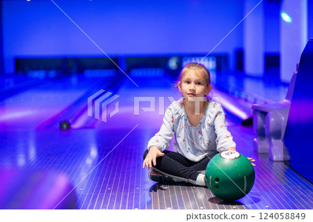 happy young girl having fun cheering while playing bowling game bowling alley happy young girl having fun cheering while playing bowling game bowling alley 124058849