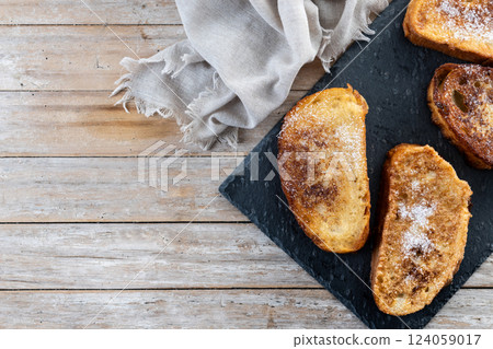 Traditional Spanish torrijas for Holy Week on wooden tableq Traditional Spanish torrijas for Holy Week on wooden tableq 124059017