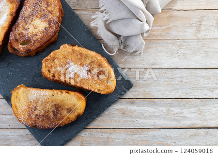 Traditional Spanish torrijas for Holy Week on wooden tableq Traditional Spanish torrijas for Holy Week on wooden tableq 124059018