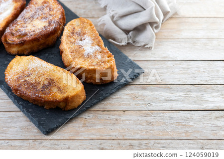 Traditional Spanish torrijas for Holy Week on wooden tableq Traditional Spanish torrijas for Holy Week on wooden tableq 124059019