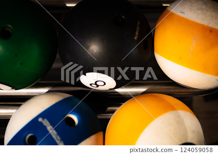 vibrant bowling ball in colorful, well-lit bowling alley with various balls and blurred background creating dynamic atmosphere vibrant bowling ball in colorful, well-lit bowling alley with various balls and blurred background creating dynamic atmosphere 124059058