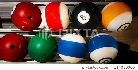 vibrant bowling ball in colorful, well-lit bowling alley with various balls and blurred background creating dynamic atmosphere vibrant bowling ball in colorful, well-lit bowling alley with various balls and blurred background creating dynamic atmosphere 124059060