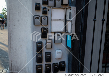 Budapest, Hungary, August 30, 2022. Short-term rental for tourist use. The gate of a building with an intercom literally surrounded by security boxes for the delivery of house keys. 124059210