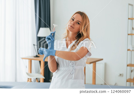 No more razor. Sugaring concept. Female doctor in white coat is standing in the clinic No more razor. Sugaring concept. Female doctor in white coat is standing in the clinic 124060097