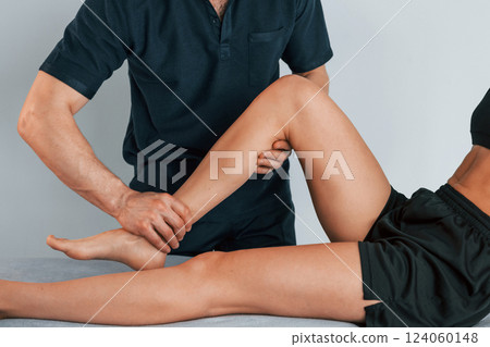 Laying down on the table. Woman visiting physiologist that making massages and helping with traumas Laying down on the table. Woman visiting physiologist that making massages and helping with traumas 124060148