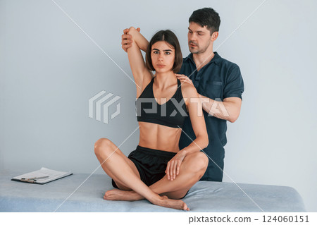 Sitting on the table. Woman visiting physiologist that making massages and helping with traumas 124060151